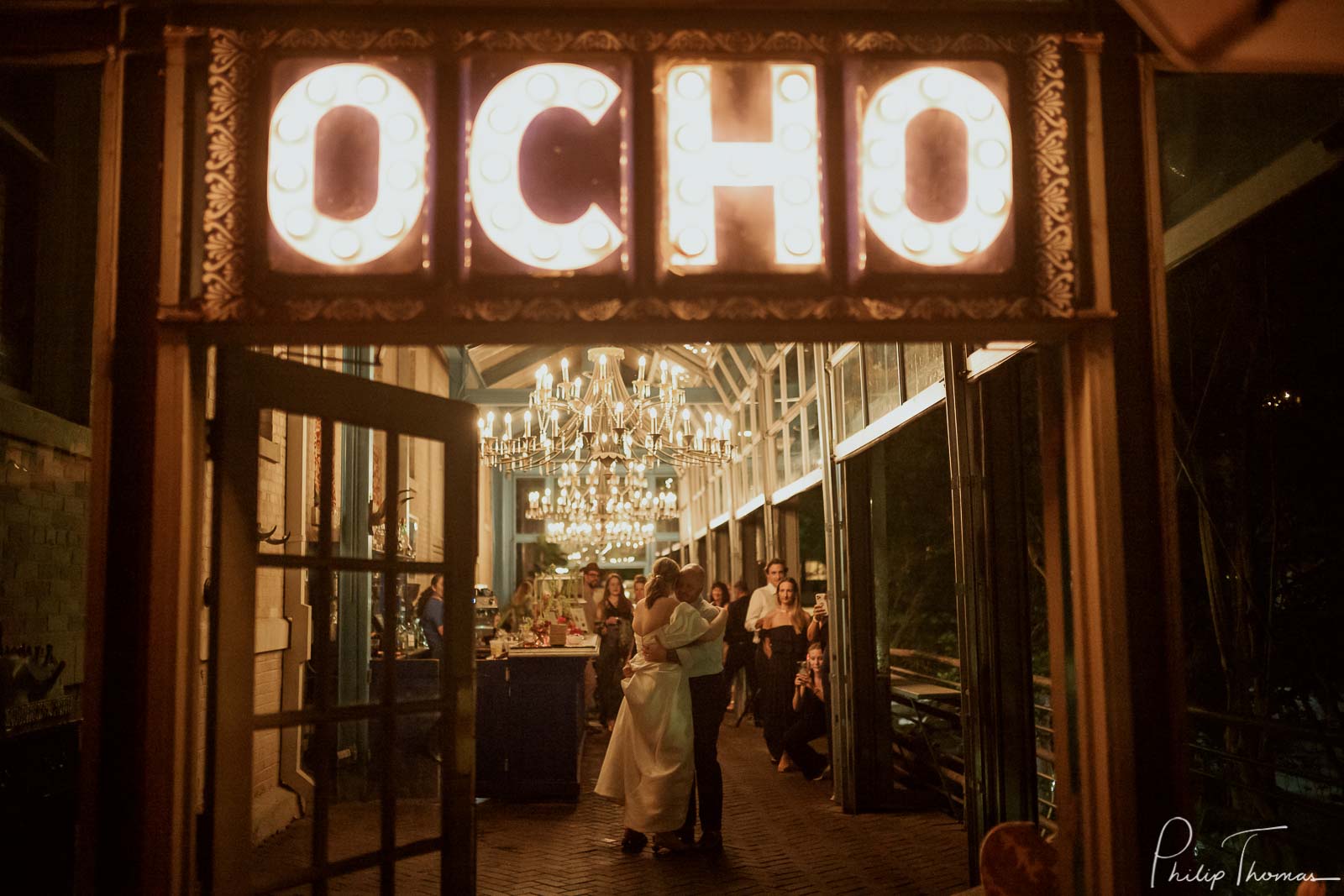 Hotel Havana and Ocho wedding and reception as couple enjoy first dance under beautiful light