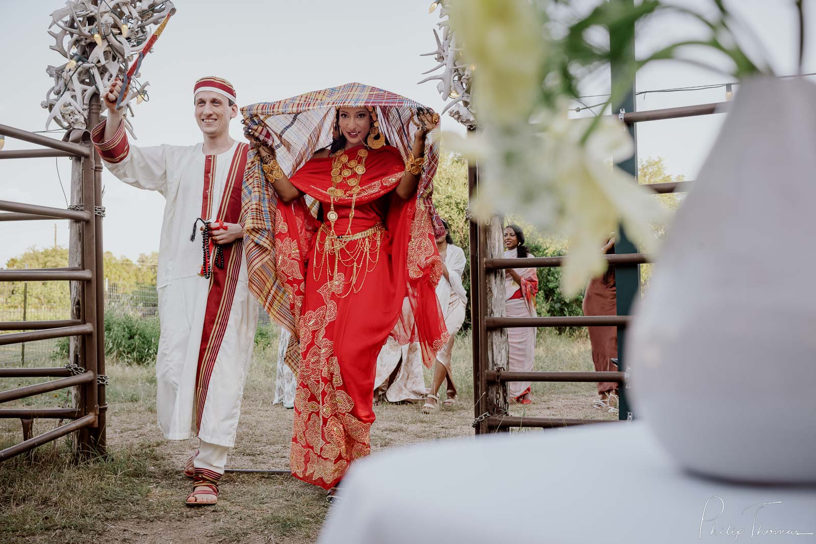 A couple enter reception at Hudson Bend Ranch Multicultural sudanese wedding Philip Thomas Photography L1001865