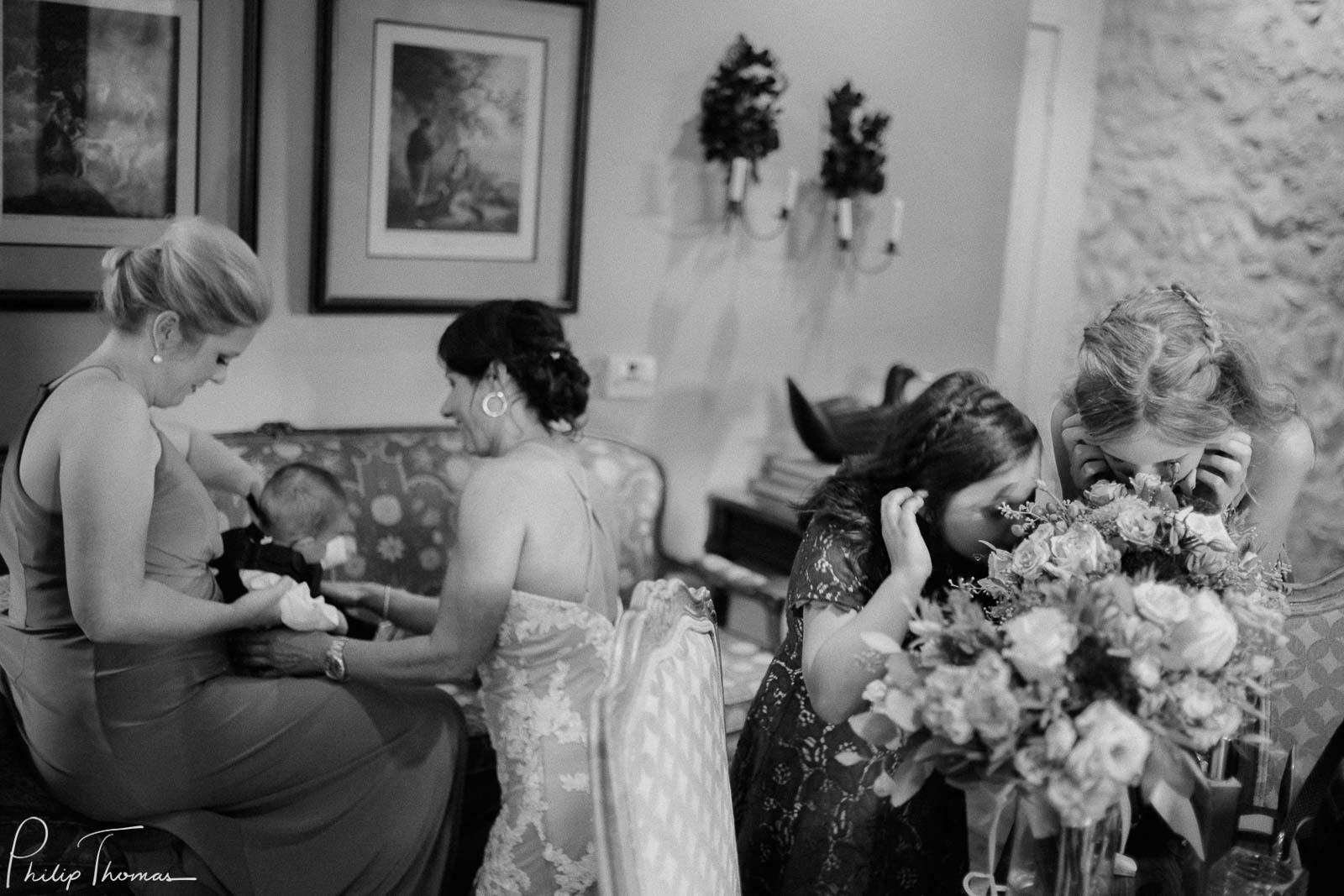 Flower girls sniff the bouquet as brides grandson is dressed for wedding at Club Giraud Wedding Reception San Antonio weddings Philip Thomas Photography