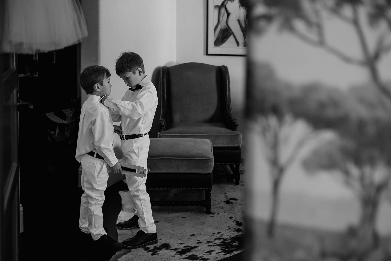 Two young ring bearers helping each other get ready San Antonio Wedding Photographer Philip Thomas Photography
