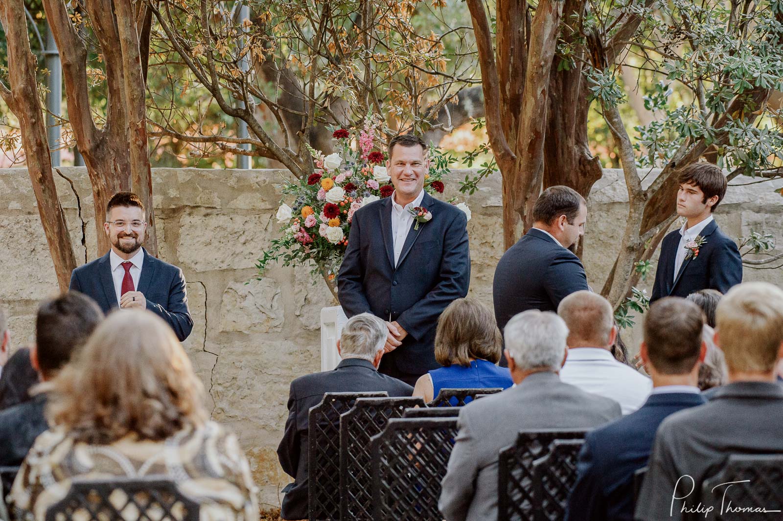 Groom smiles upon his bride walking down aisle Club Giraud Wedding Reception San Antonio weddings Philip Thomas Photography