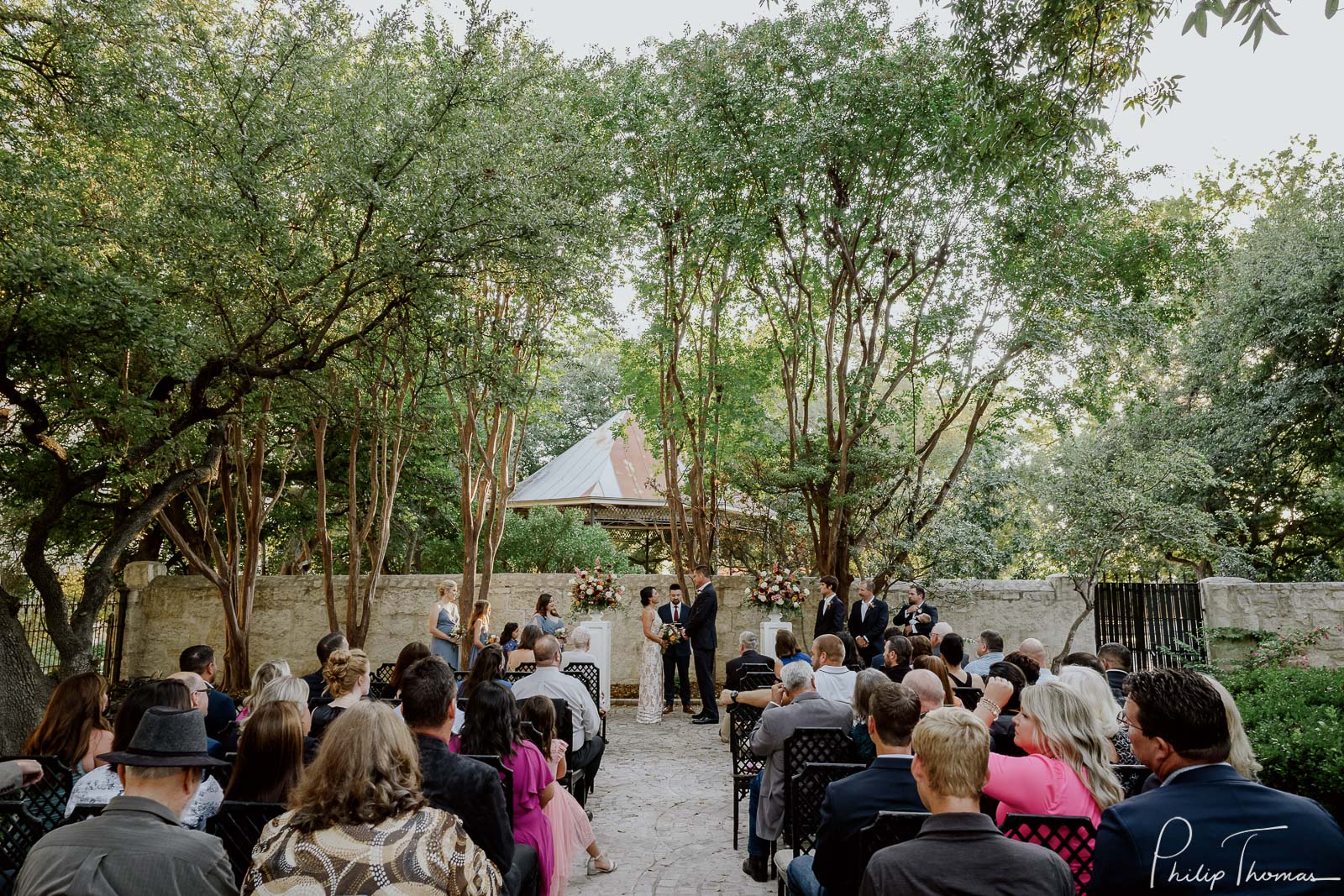 Wide angle from back. of ceremony in courtyard Club Giraud Wedding Reception San Antonio weddings Philip Thomas Photography