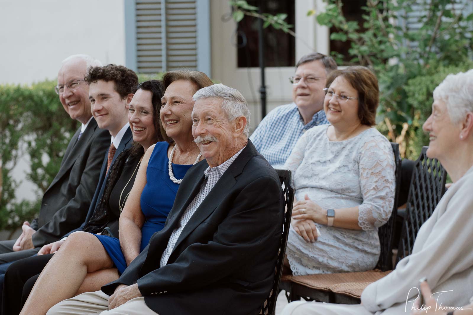 Family share joy and laughter during ceremony atClub Giraud Wedding Reception San Antonio weddings Philip Thomas Photography