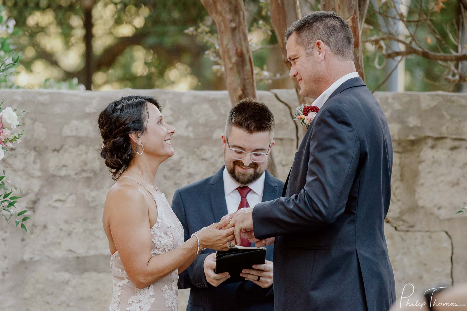 The bride looks up to her husband as they hold hands during the vows Club Giraud Wedding Reception San Antonio weddings Philip Thomas Photography