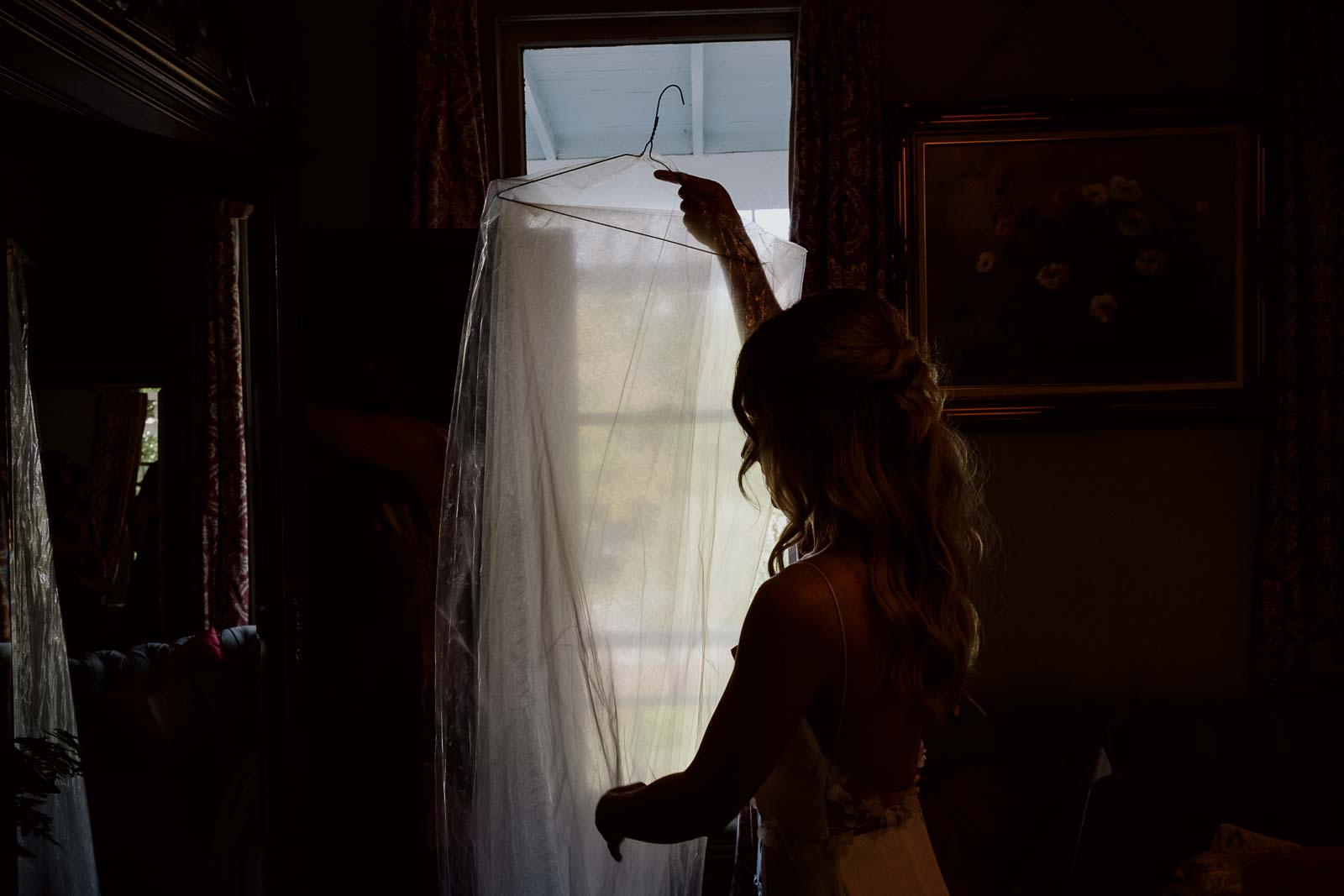 A bride brings the steamed veil from the bathroom to the bridal room