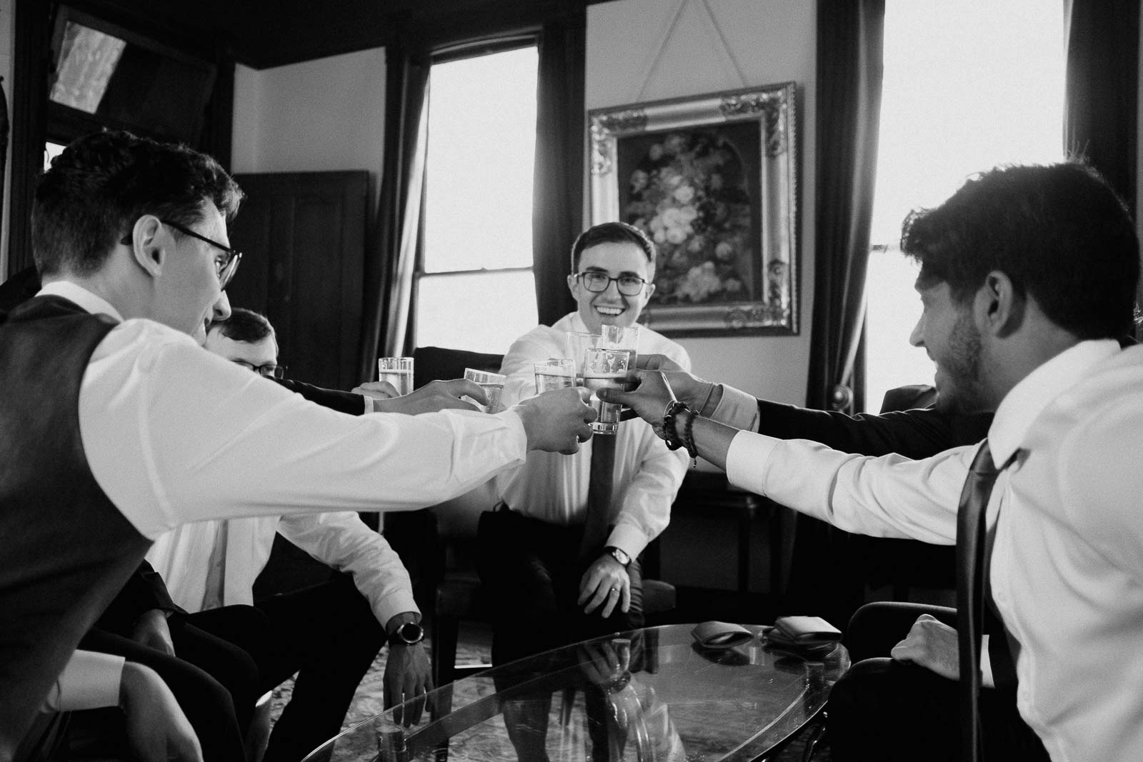 Groomsmen raise their glasses in a toast