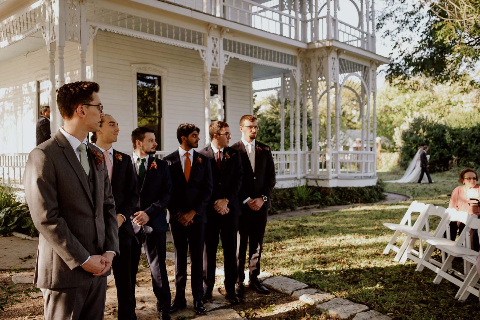 The groom looks to his left as the bride and father walk down the aisle at Barr Mansion.