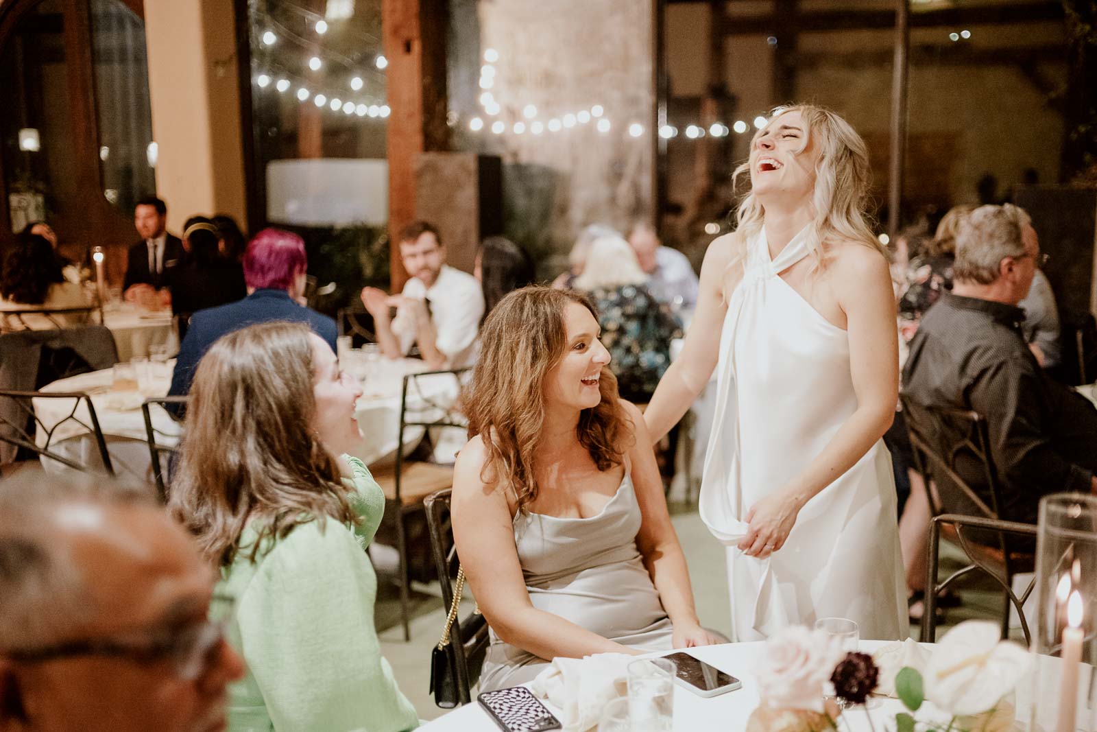 The bride shared a light hearted moment with one of guests around a table