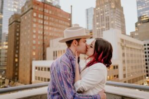 Couple kiss at Saks Garage engagement session in downtown Houston, Texas
