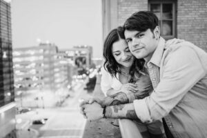 Saks Garage black and white show couple cuddling in a engagement session in downtown Houston, Texas
