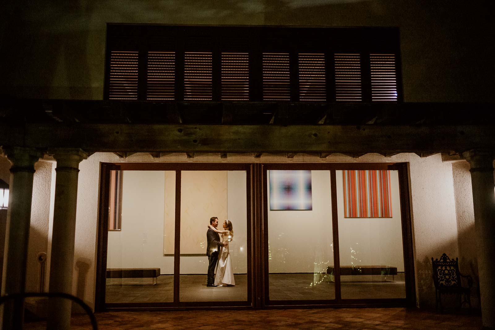 A couple practice their first dance in the McNay's art gallery 