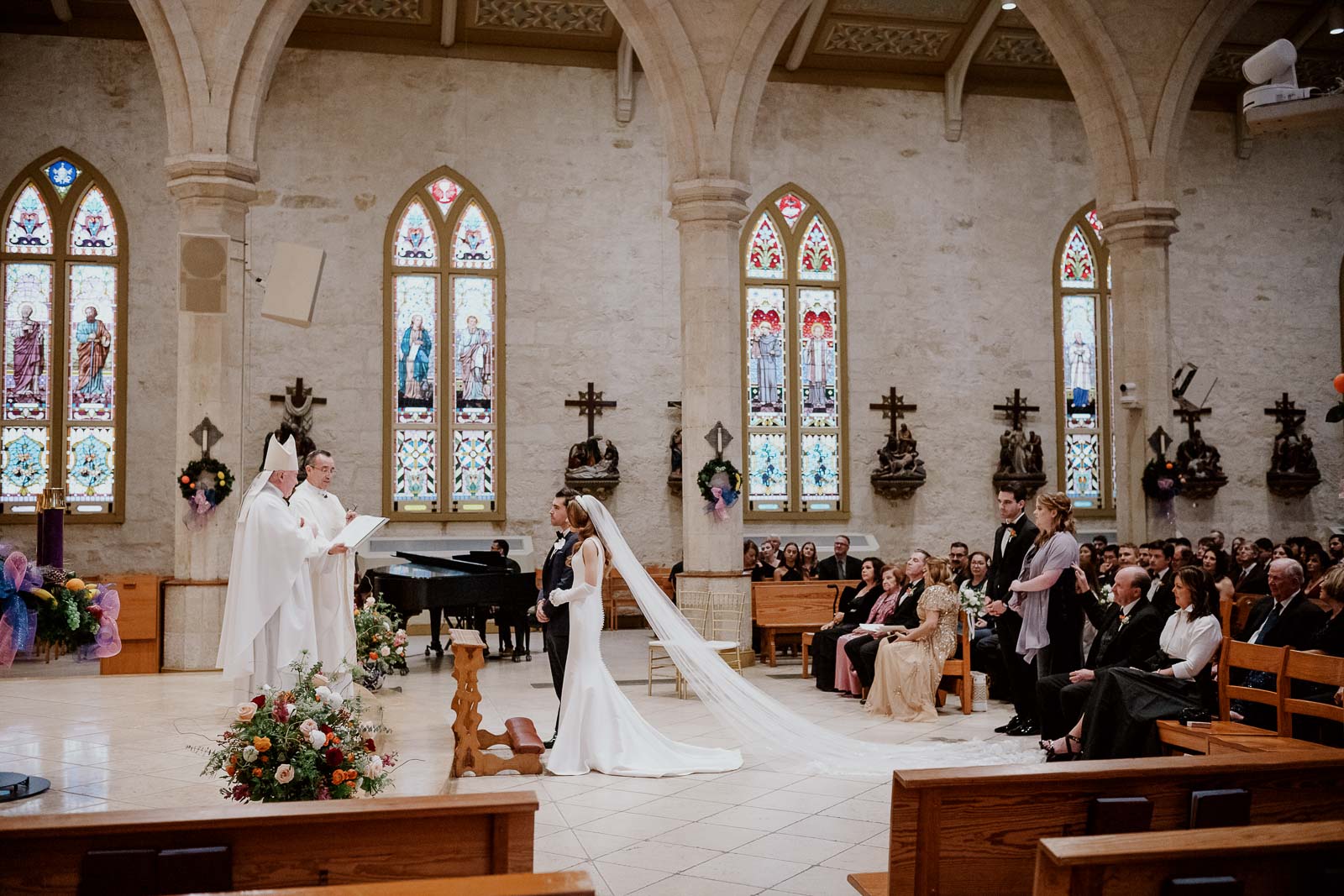 A wide angle shot of the bishop, priest, the couple and parents during a wedding at San Fernando Cathedral