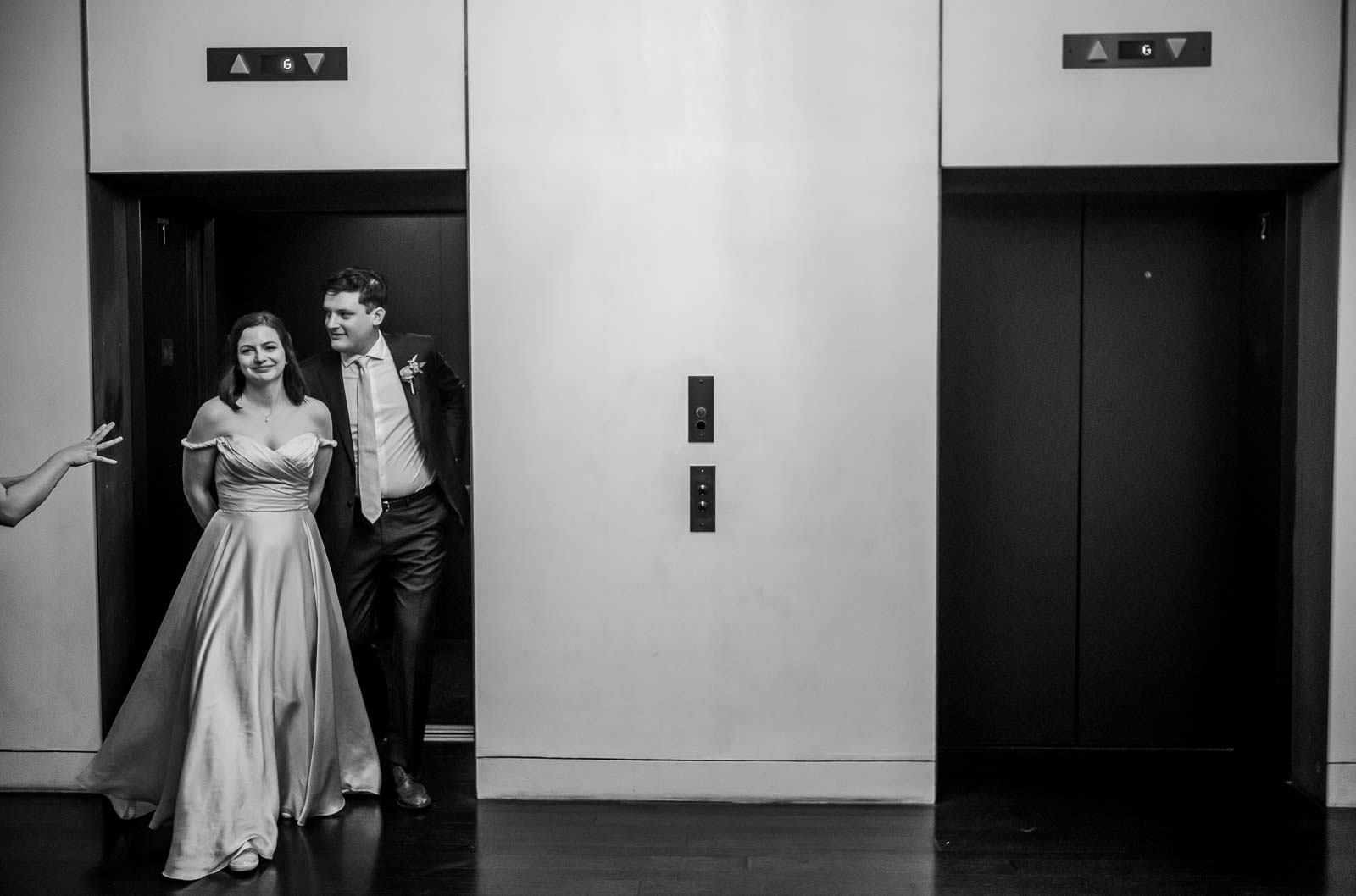 Handsome couple exit an elevator on the way to their wedding reception in Texas, USA.
