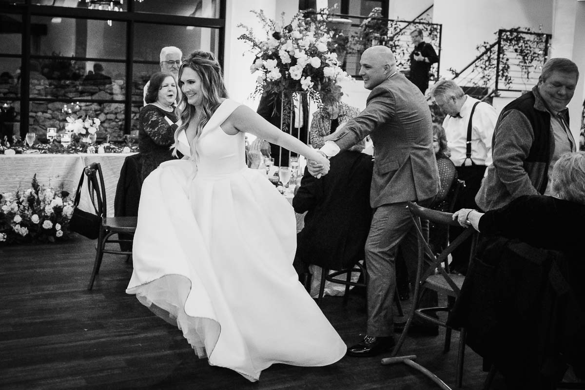 Wedding couple make their way to the reception floor during the announcement at Hayes Hollow at Hidden Falls in Spring Branch