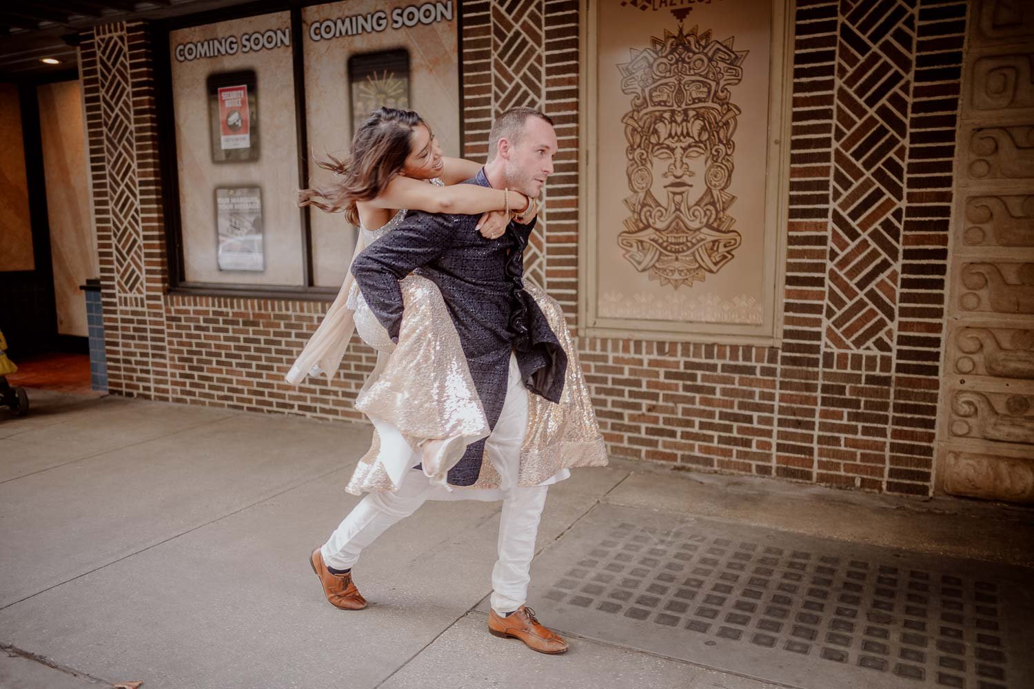 A fun and impromptu  moment as groom gives piggyback ride to bride during engagement session in the Alamo city that is San Antonio, Texas.