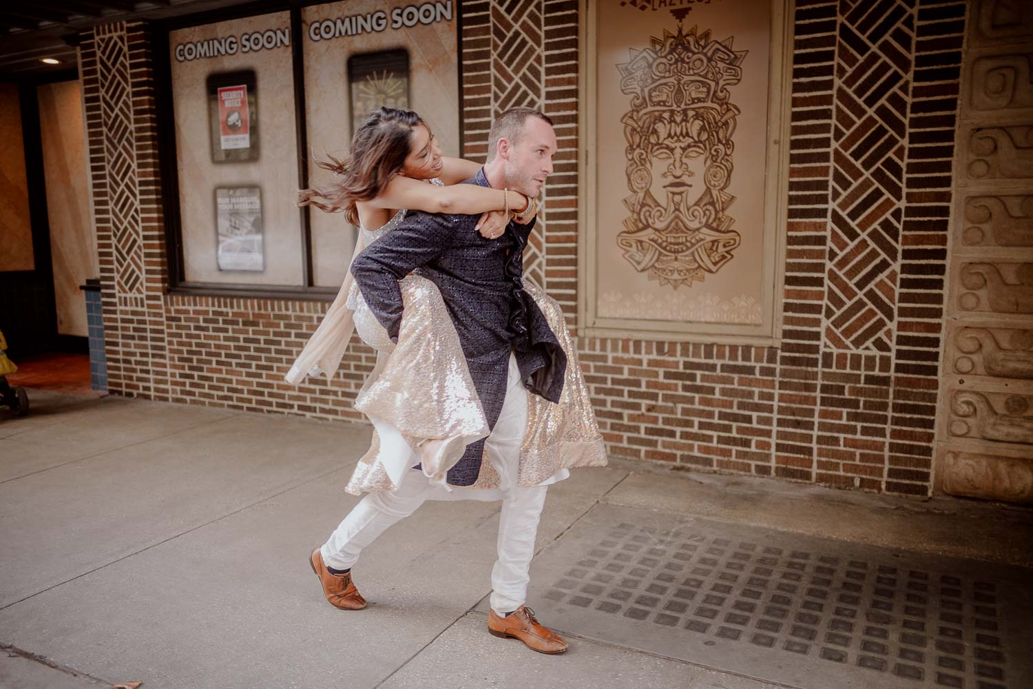 A fun and impromptu moment as groom gives piggyback ride to bride during engagement session in the Alamo city that is San Antonio, Texas.