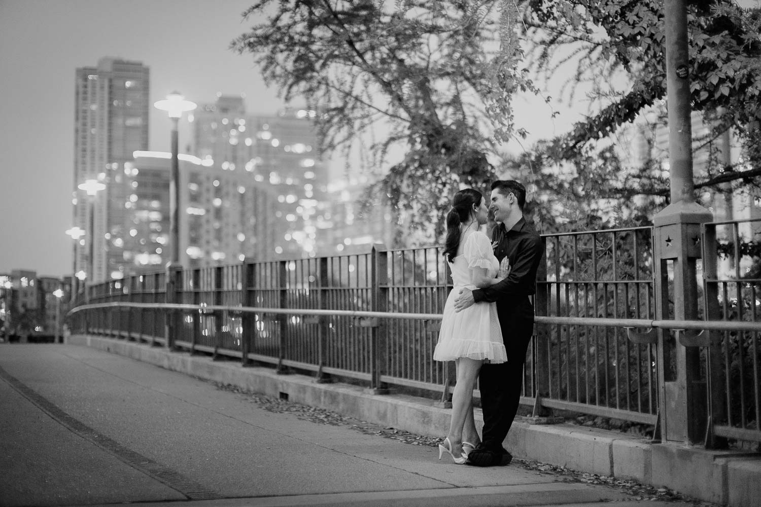 Couple snuggle on the Pfluger Pedestrian Bridge Austin Downtown Engagement Session-