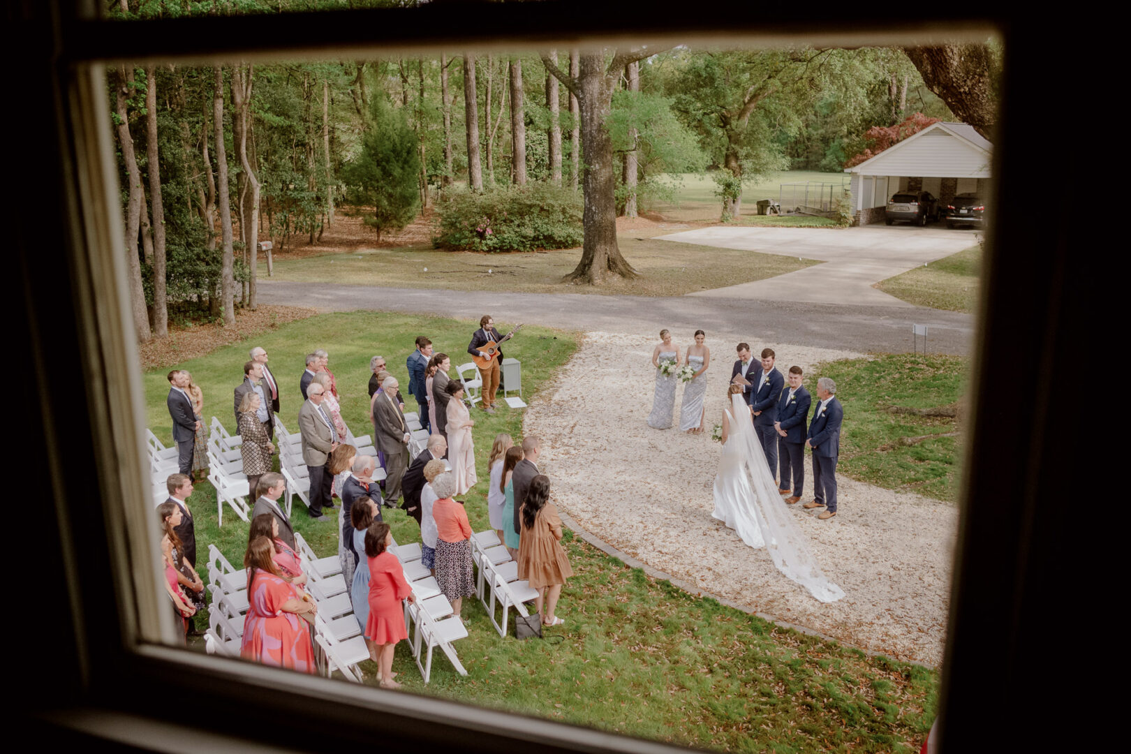 A home wedding for this lucky photographer in Georgia, South Carolina. Photographed through the window toward their ancient oak tree. L1008593