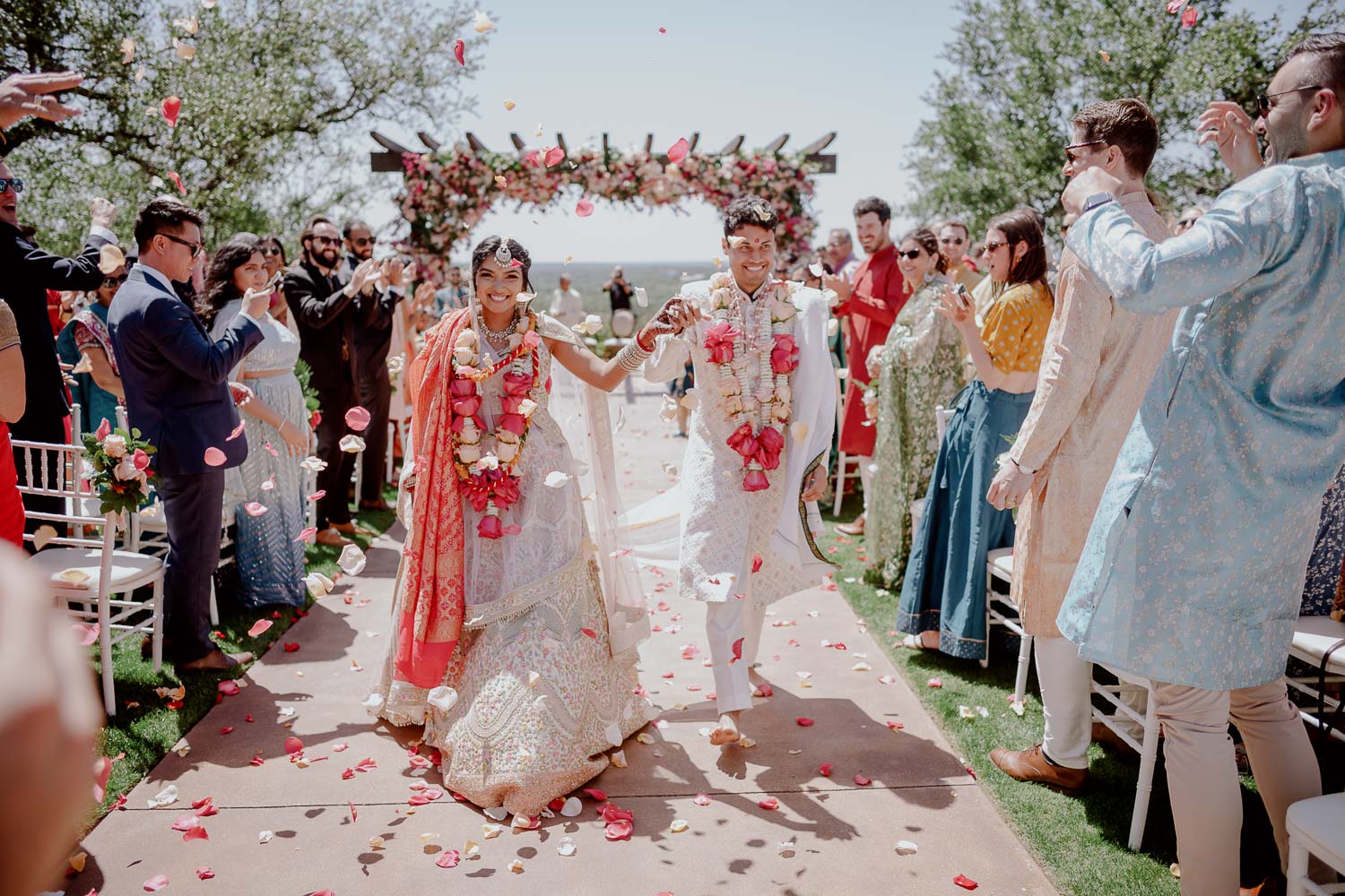 The happy couple walk down the aisle at Canyonwood Ridge Hindu Wedding Ceremony Reception Austin Leica photographer Philip Thomas Photography