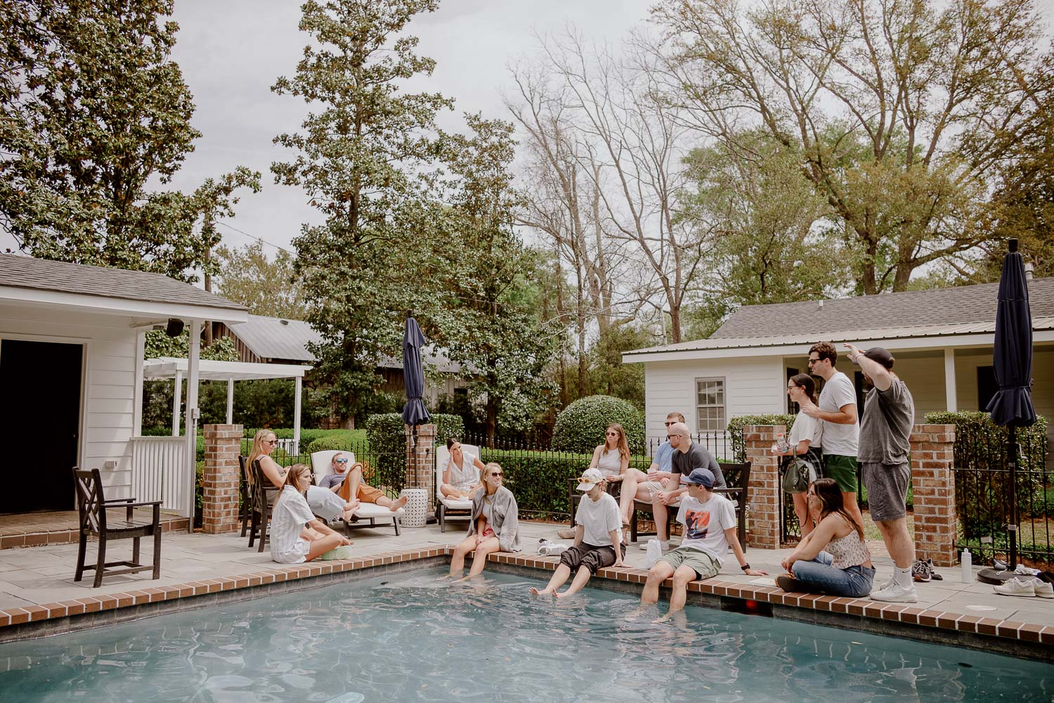 Friends gather around the pool on brides wedding day in Georgetown South Carolina Wedding photojournalist Philip Thomas Photography