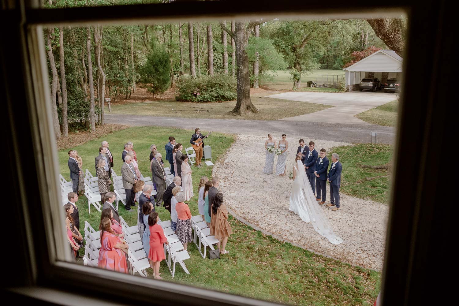 Home wedding photographed through window as bride enters ceremony in Georgetown South Carolina Wedding photojournalist Philip Thomas Photography L1008593