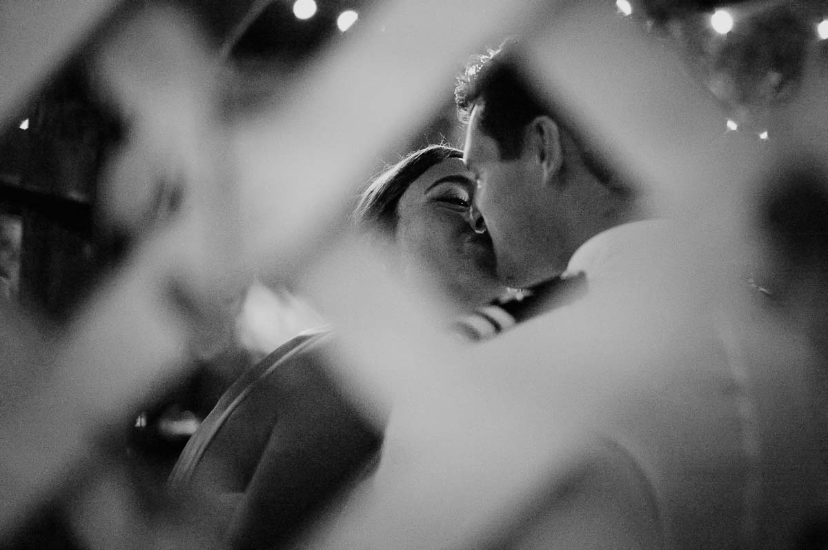 A kiss after cutting the cake at The Kendall in Boerne Wedding Philip Thomas Photography l1003052