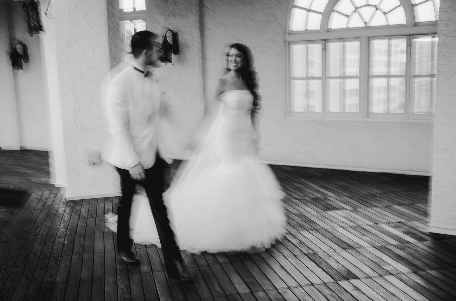 Motion blur dragged shutter couple on terrace at St Anthiny Hotel in San Antonio after a rain showerL1007056