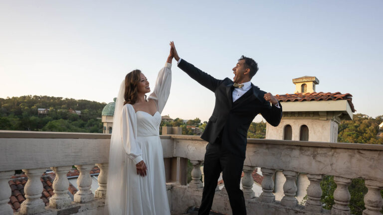 A Wedded couple high five at a South Asian Wedding at Villa Antonia L1100269