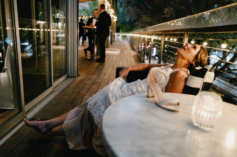 Bride takes a moment to soak it all in during a wedding reception L1042645-Philip Thomas