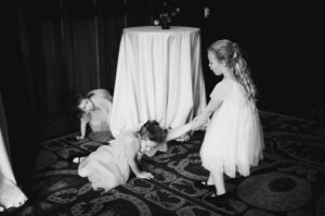 Tips to find the perfect photographer - Girls play around a table 18 A beautiful winter wedding at San Antonio's Iconic Hotel Emma Philip Thomas PhotographyL1007504