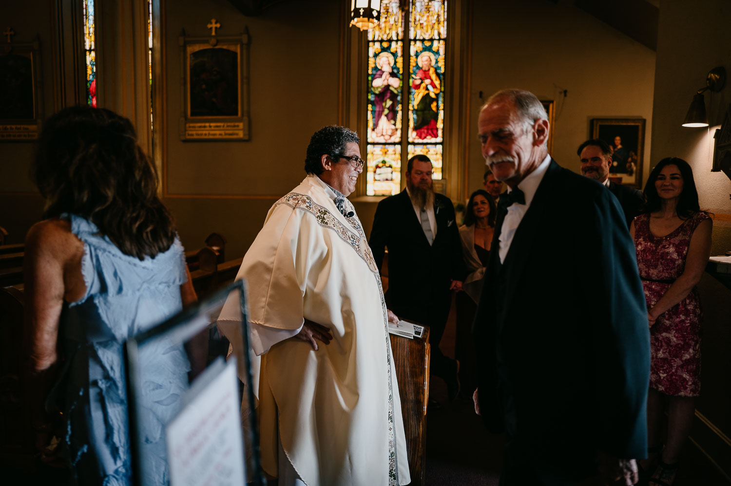 Wedding Ceremony St. Joseph's + The Westin Riverwalk, San Antonio 19 a man in a suit and priest standing in a church