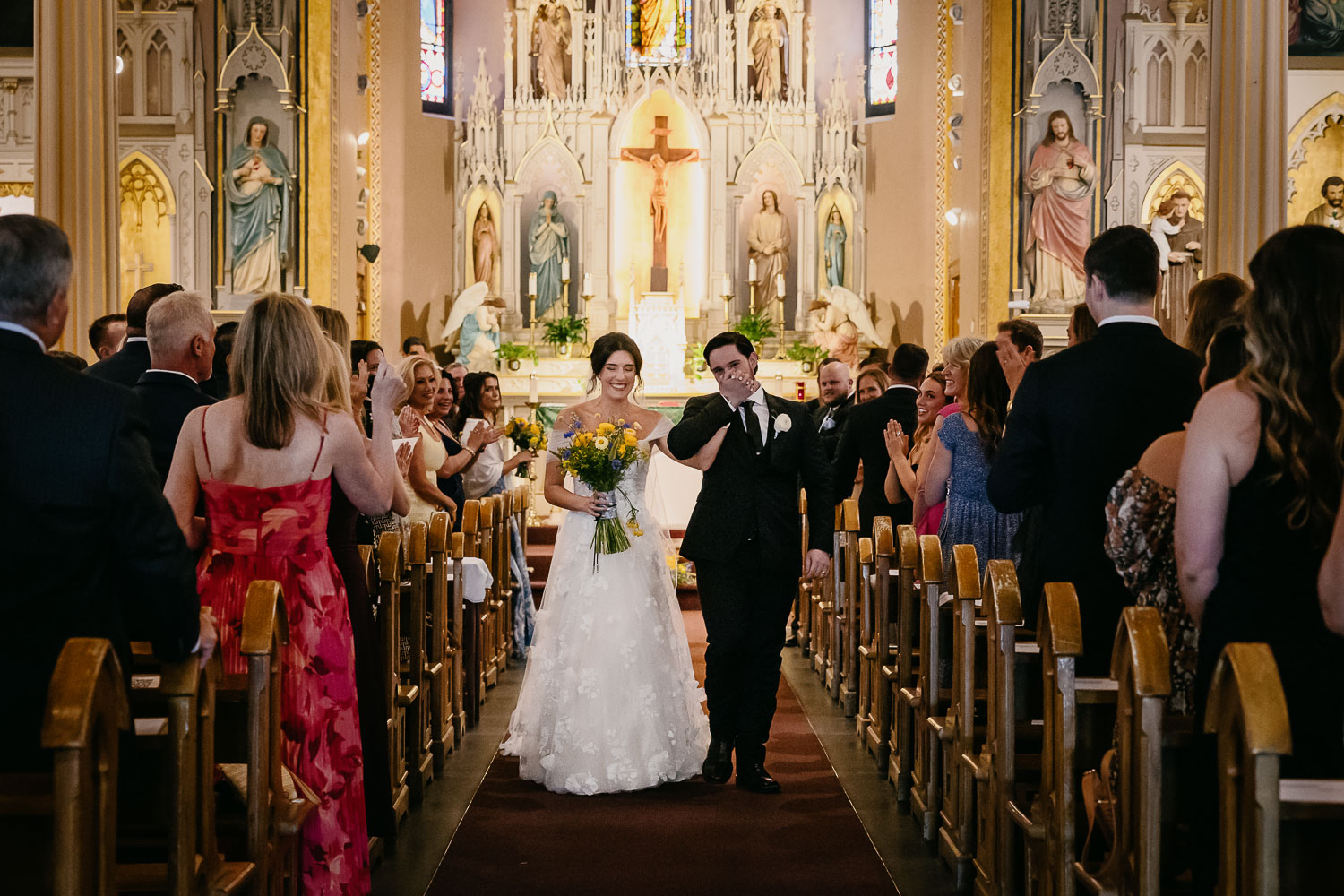 Wedding Ceremony St. Joseph's + The Westin Riverwalk, San Antonio 34 a bride and groom walking down a aisle in a church