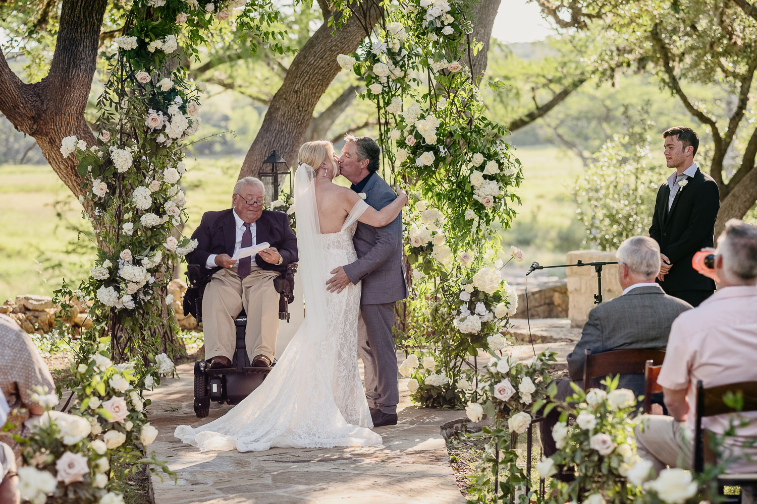 a man kissing a woman in a wedding dress