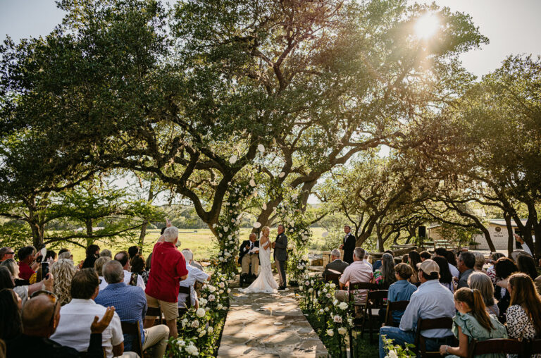 Texas Tech weddings, a tortilla-throwing tradition is incorporated to celebrate the couple, drawing inspiration from the university's football game tradition a man and woman under a tree on their wedding day