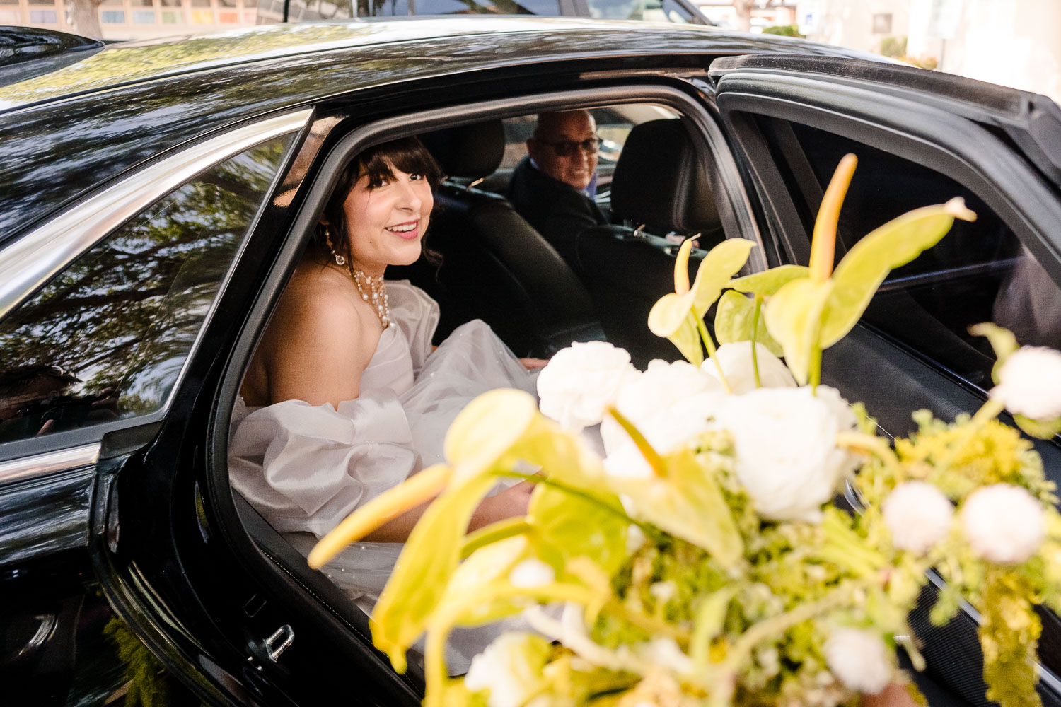 St. Patrick Catholic Church | Art Museum of South Texas Corpus Christi 25 a woman in a white dress sitting in a car with a bouquet of flowers