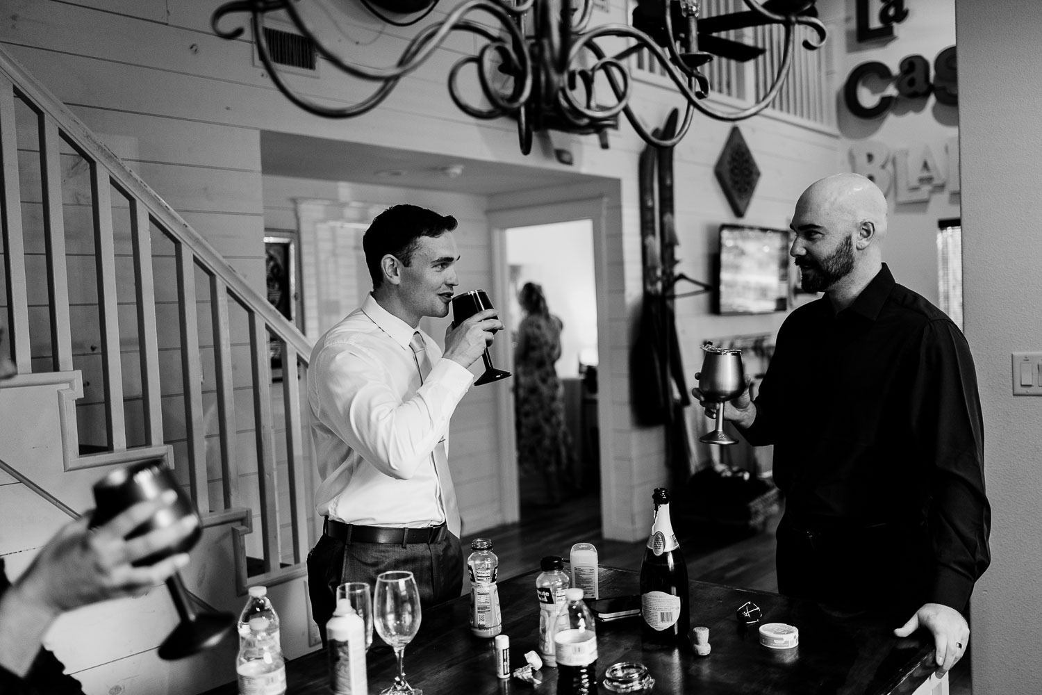 Two men toasting with drinks.