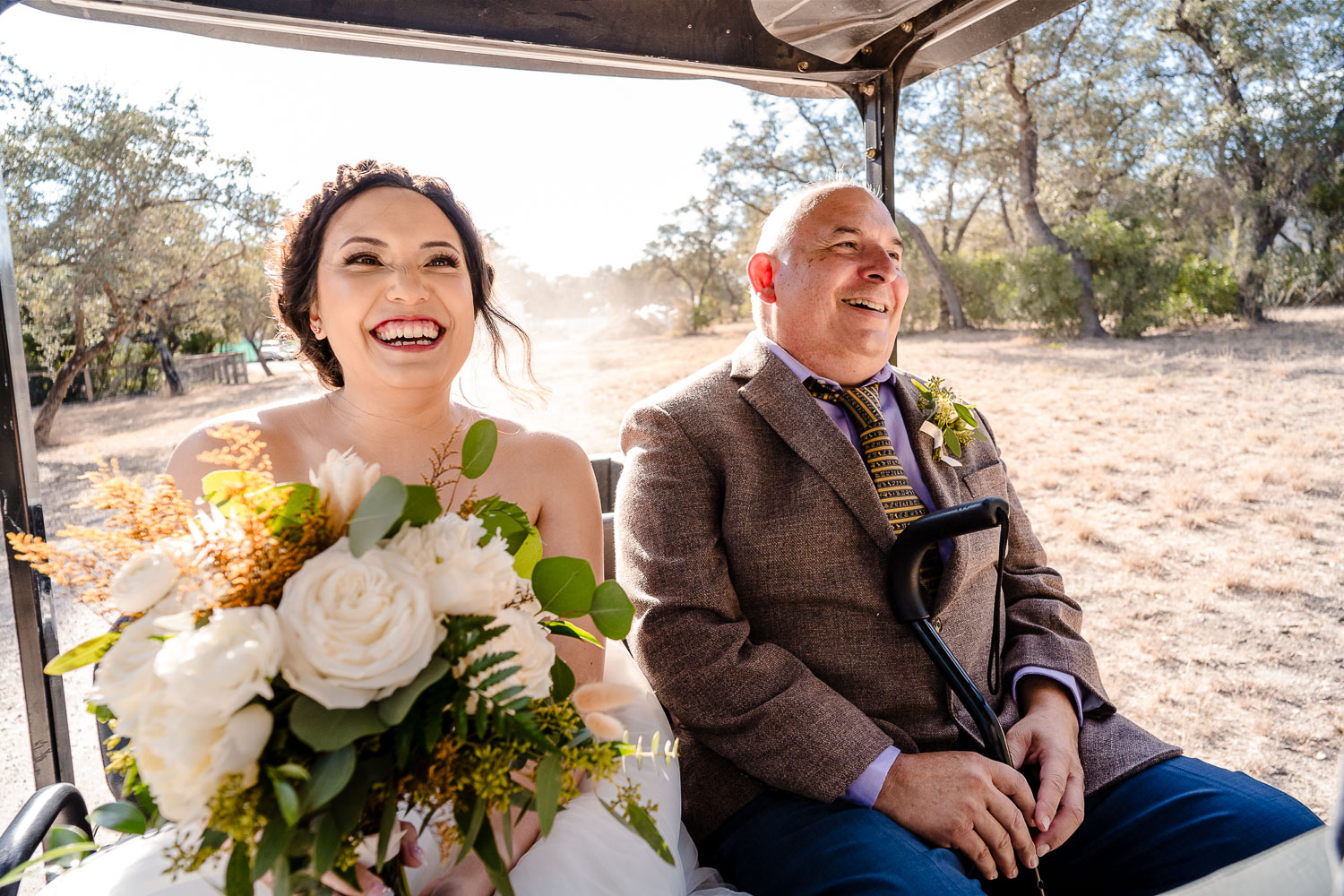 Couple riding in golf cart together.