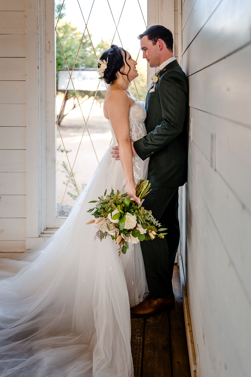 Bride and groom in romantic pose.