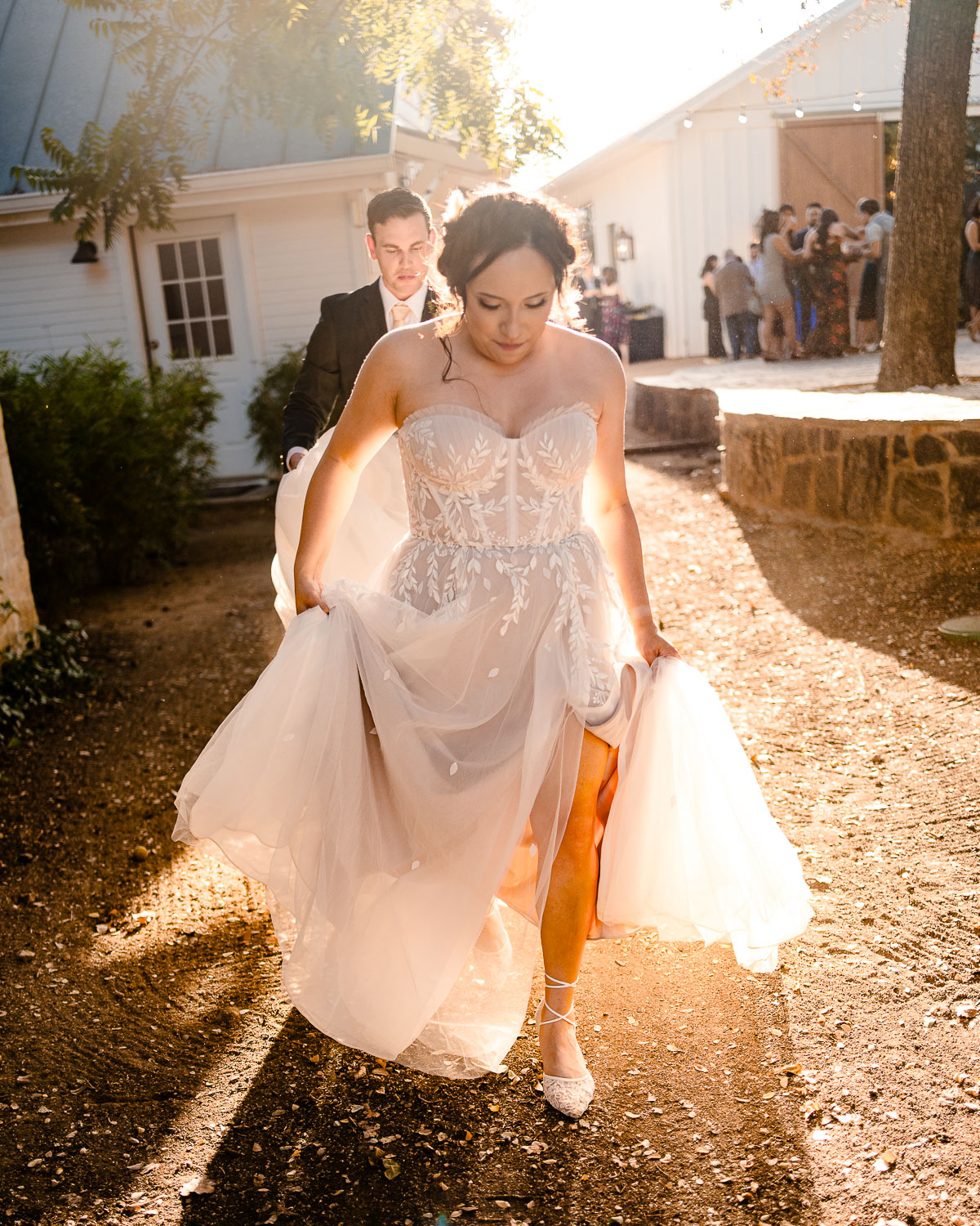 Bride walking in golden sunlight.