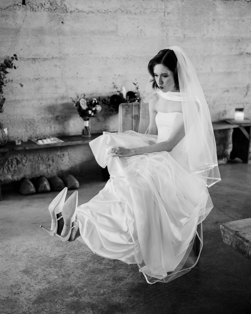 Ice Plant Bldg Wedding | La Grange | Zoe+Patrick 18 Bride adjusting her elegant wedding dress.