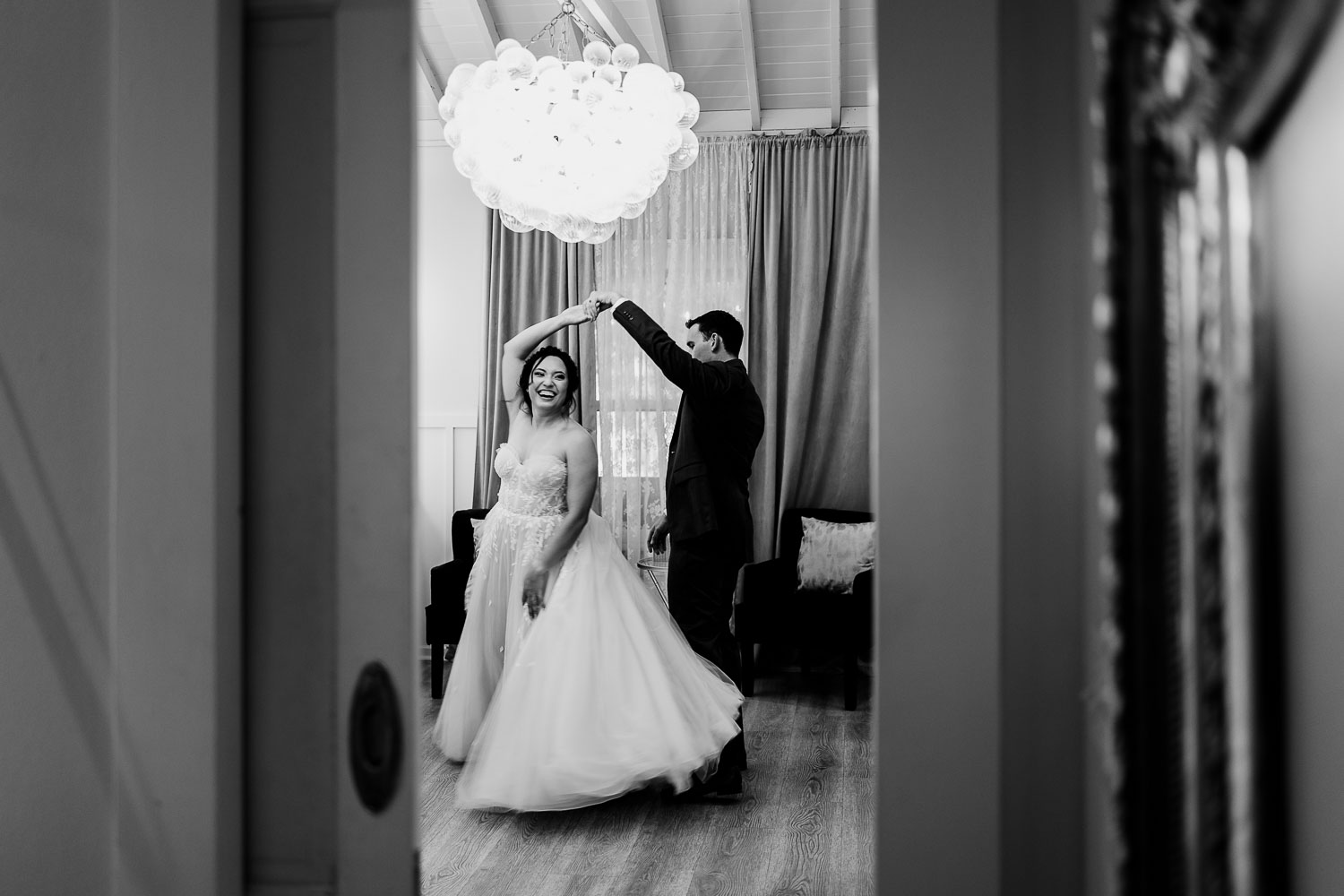 Couple dancing joyfully in elegant setting.