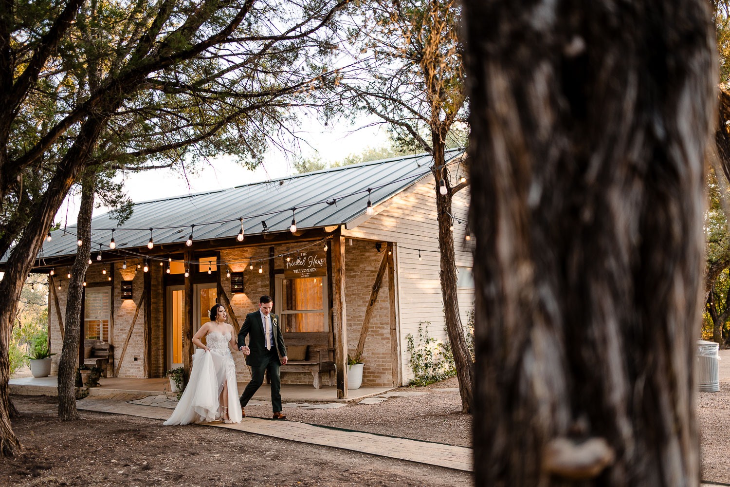 Couple walking towards charming venue.