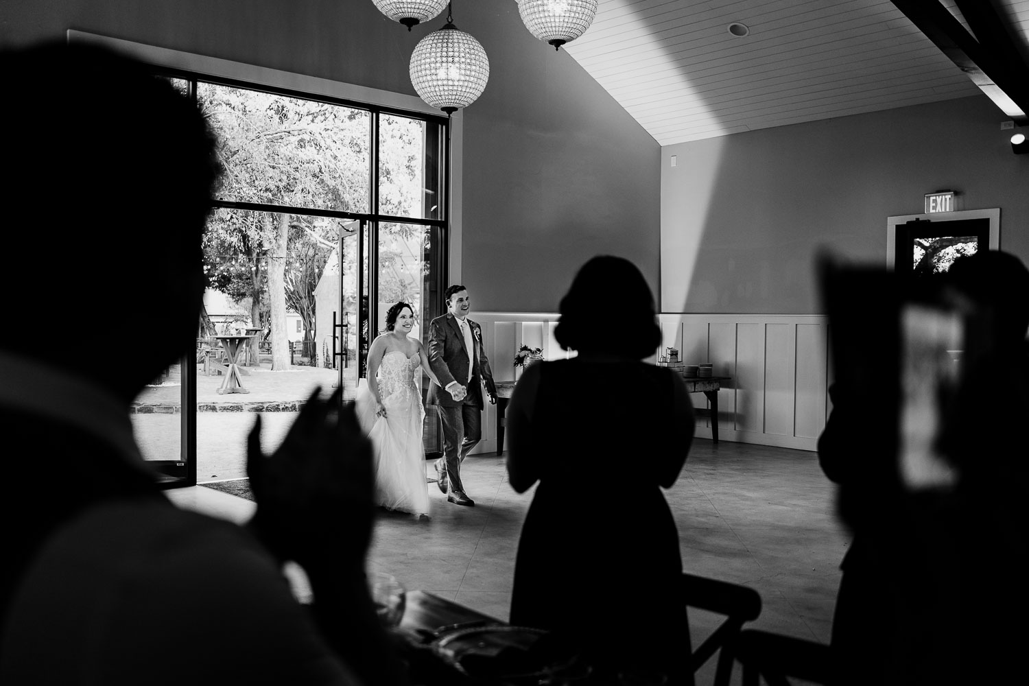 Bride and groom entering reception venue.