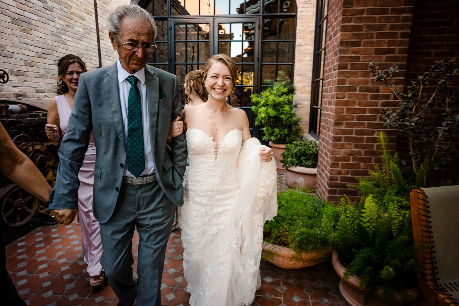 Botanical Gardens San Antonio Wedding Ceremony + Reception 22 Bride walking with her father outdoors.