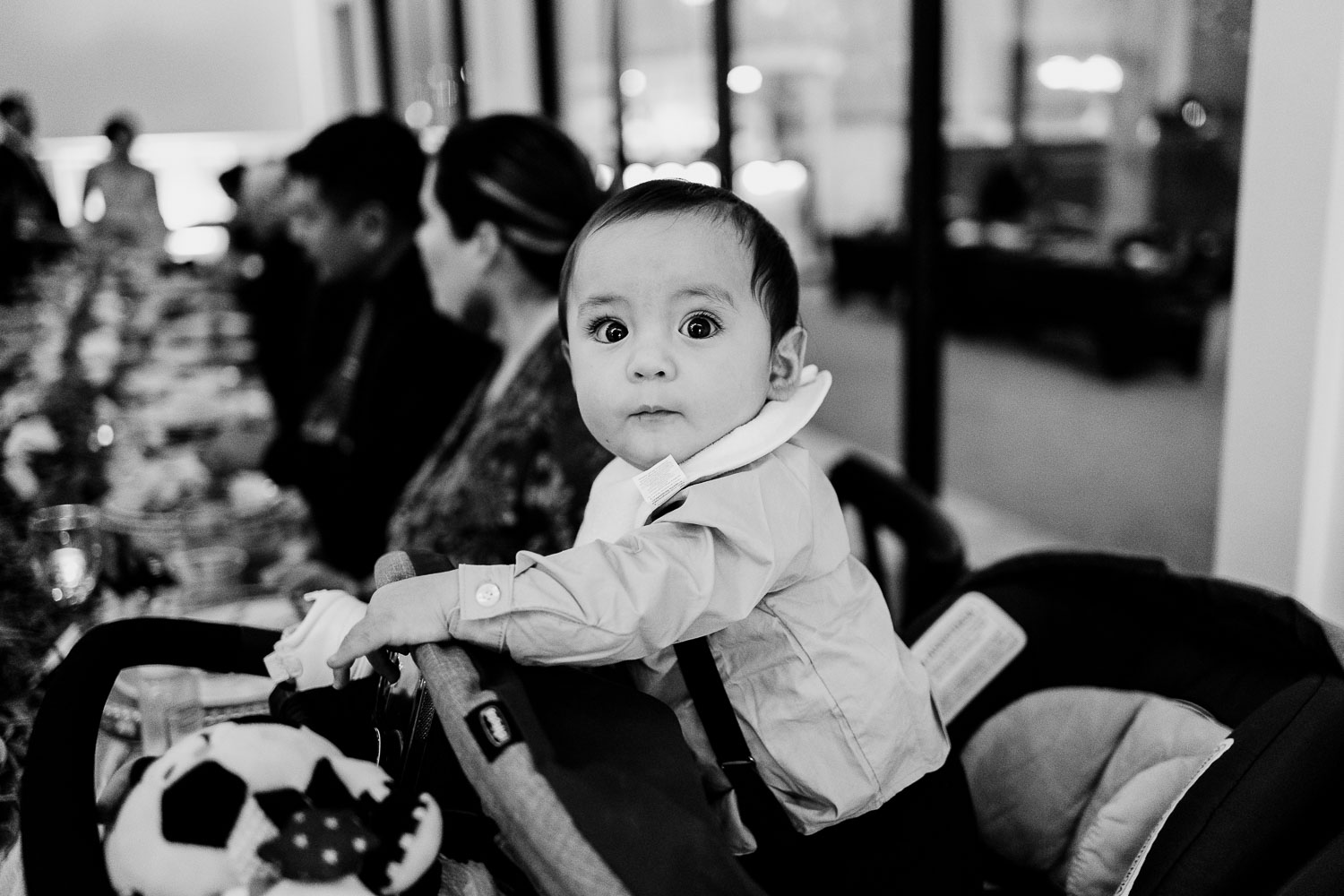 Child in stroller at wedding reception.
