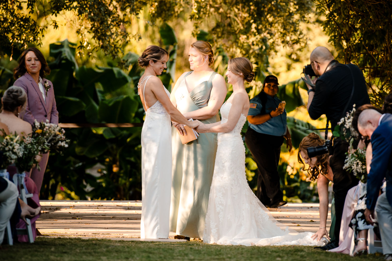 Botanical Gardens San Antonio Wedding Ceremony + Reception 28 Brides exchanging vows in garden setting.
