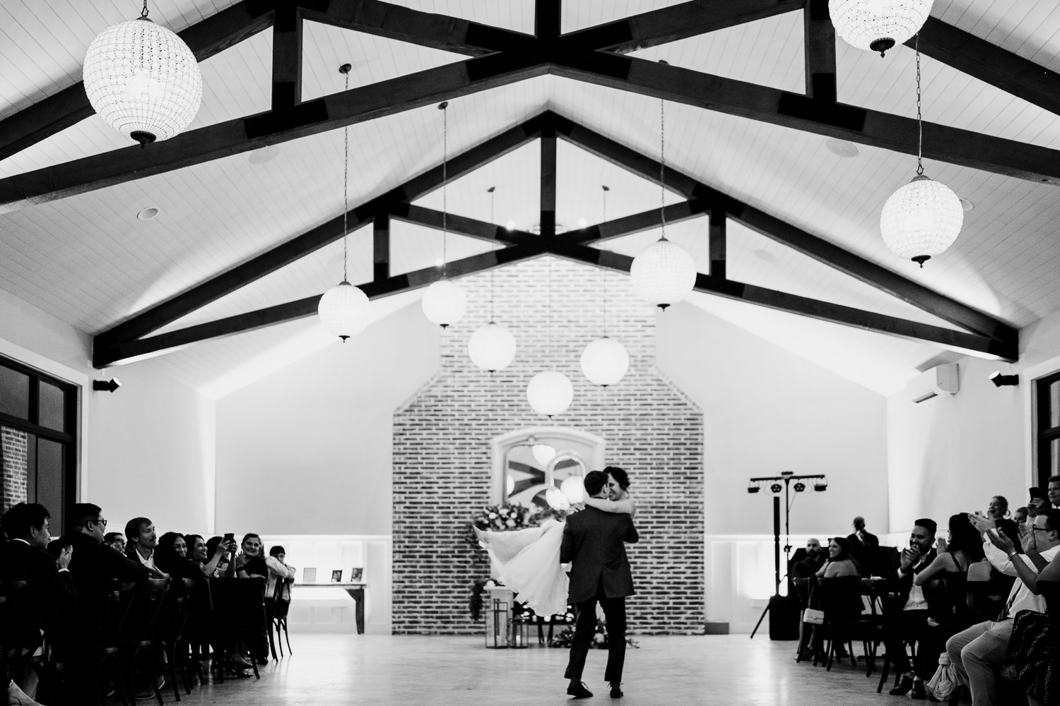 Couple dancing in a beautifully decorated venue.