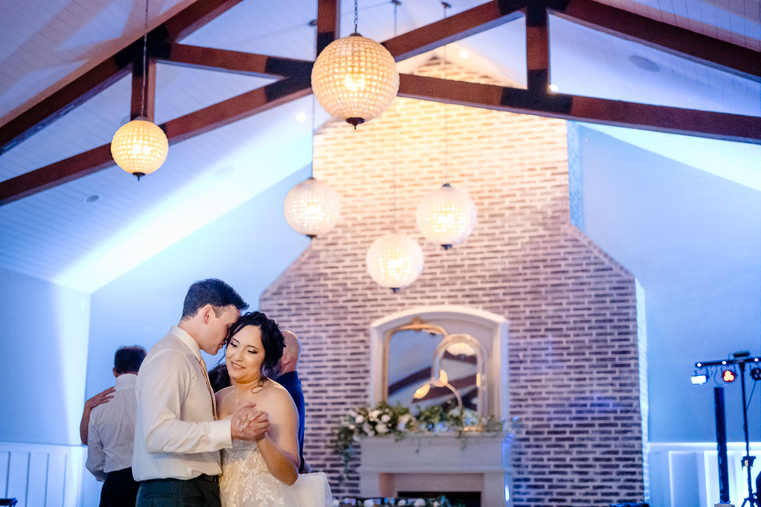 Couple dancing in a beautifully decorated venue.