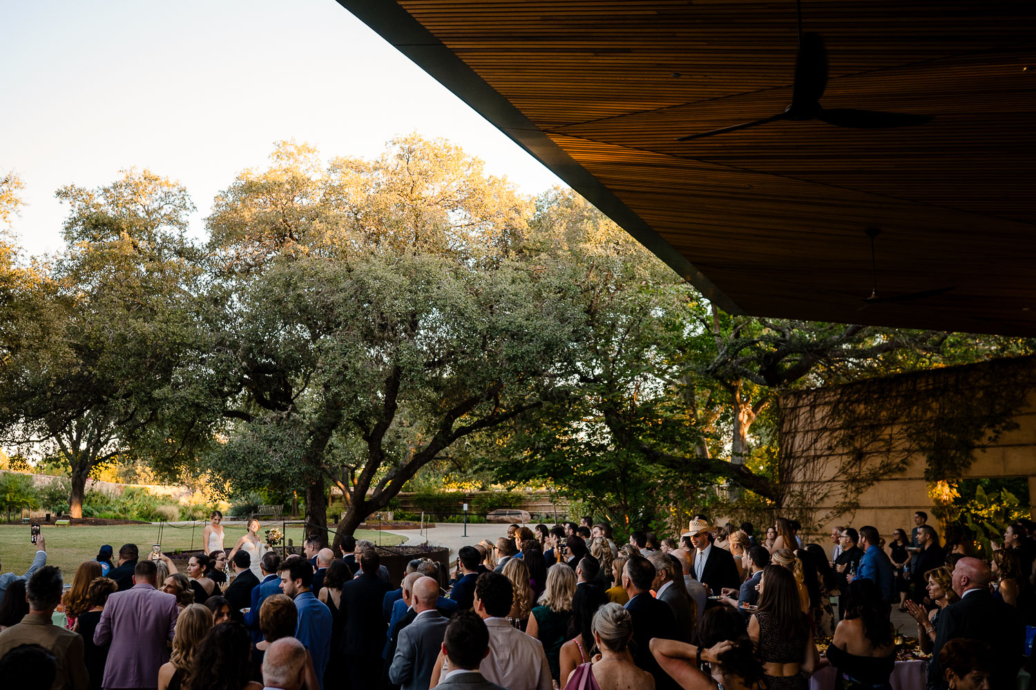Botanical Gardens San Antonio Wedding Ceremony + Reception 42 Outdoor wedding reception with guests gathered.