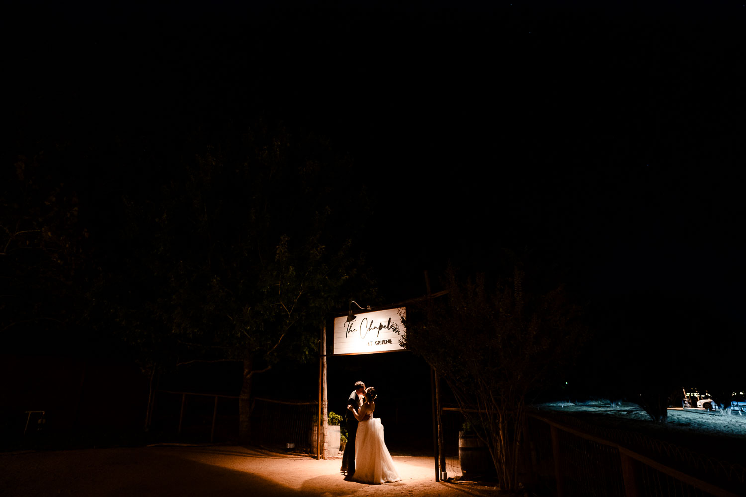 Couple embracing under night sky.